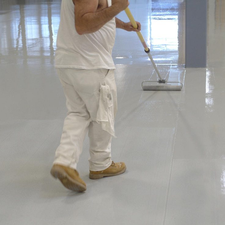 a worker rolls an epoxy paint onto a new warehouse floor
** Note: Slight blurriness, best at smaller sizes